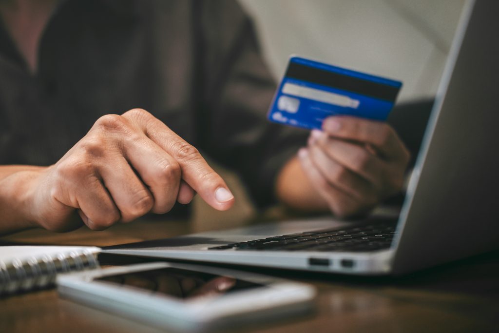 Businessman holding credit card and typing on laptop for online shopping and payment makes a purchase on the Internet, Online payment, Business financial and technology.
